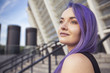 © AnnaDemy - Beautiful brunette woman with colored (purple violet blue) hair in dark black slim dress outdoor in the european city, smiling