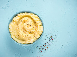 Wall Mural - Mashed potatoes on blue concrete background