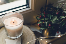 Christmas Candle By A White Window