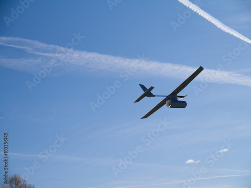 drone airplane, low altitude passage, sunny sky with clouds Poster
