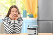 © Africa Studio - Young woman listening to radio in kitchen