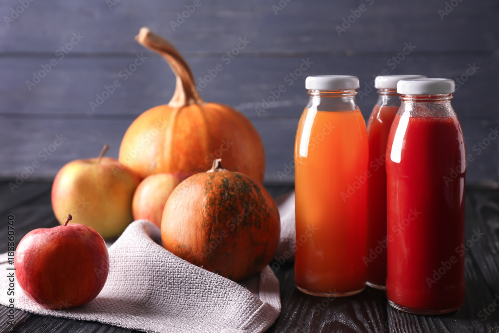 Bottles of fresh juices and ingredients on table
