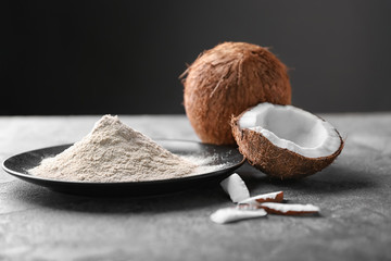 Poster - Plate with coconut flour and fresh nuts on table