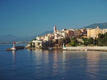 Corsica Bastia Port View From Sea On Harbor With Red And Green Lighthous Church And Old Town Blue Sky Background