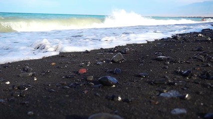 Wall Mural - The waves roll on the pebble beach. Slowmotion 240 FPS 
