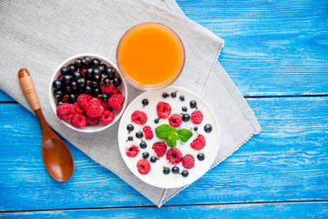 Wall Mural - tasty yoghurt with raspberry on wood blue table