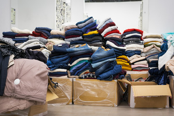 stock clothing - a collection jeans, sweaters, jackets in modern distribution warehouse in the mall.