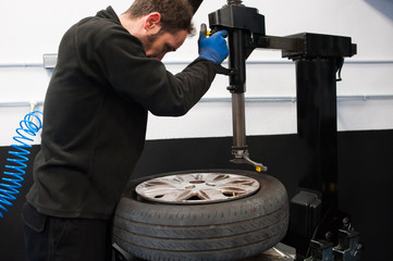 Wall Mural - worker changing a tyre