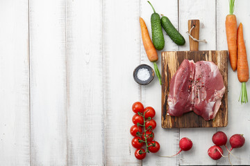 Wall Mural - Raw duck breast or fillet steak and fresh vegetables on white wooden background, top view