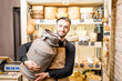 Portrait of a cheese seller with big dairy bucket standing in the cheese shop