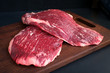 © Andrey - raw flank beef on a wooden Board