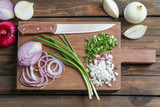 Fototapeta Tulipany - Fresh cut onion on wooden board