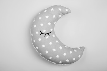 Wall Mural - Soft pillow in shape of moon on light background