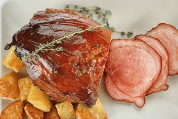 Wall Mural - Traditional honey baked ham and potatoes on light background, closeup