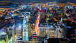 Aerial Philadelphia cityscape by night with the City Hall tower in the foreground and Ben Franklin bridge spanning Delaware river in the back
