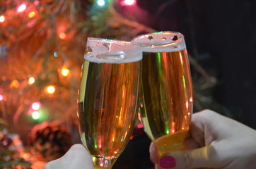 Christmas party drinking concept, glass of champagne with gift box on bokeh background