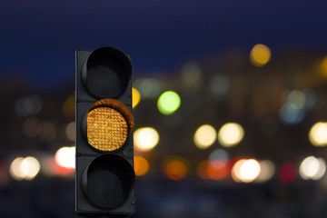 Car yellow traffic light at night with the timer on the background of the car. Night crossroad.