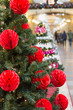 © svetlana_cherruty - Christmas tree with holiday red balls and lights with copy space on blurred bokeh background in mall. Close up.