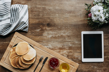 Wall Mural - top view of breakfast with pancakes and digital tablet on wooden table