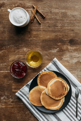 Wall Mural - top view of pancakes with coffee cup on wooden table