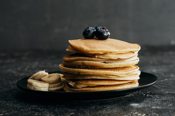 Wall Mural - delicious stacked pancakes with blueberries and sliced banana