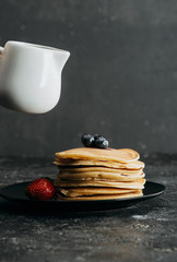 Wall Mural - stack of tasty pancakes with milk jug above
