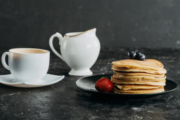 Wall Mural - plate of delicious stacked pancakes with cup of coffee