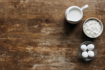 Wall Mural - top view of ingredients for pastry on wooden table