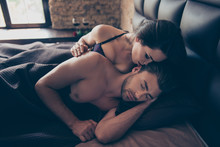 It Is Just A Dream, Just My Erotic Fantasy! Close Up Photo Of Passionate Attractive Charming Brunette Tempting Woman Whispering Pleasant Words To Her Sleepy Man, They Are Lying In Bed Under A Blanket