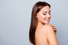 Close Up Portrait Of Beautiful Amazing Fresh Young Woman With Toothy White Smile, Brown Hair, She Is Looking Down On Her Shoulder And Touching It With A Hand, Isolated On Grey Background, Copyspace