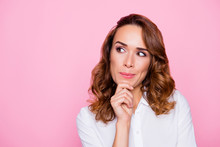 Close Up Portrait Of Curious Cheerful Charming Attractive Woman With Ideal Hairdo And Make Up, She Is Thinking About The Right Choice And Touching Chin, Isolated On Bright Pink Background, Copyspace