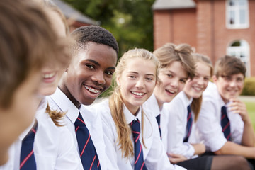 Wall Mural - Group Of Teenage Students In Uniform Outside School Buildings