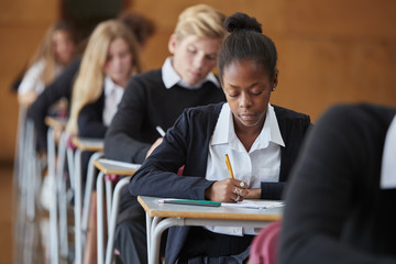 Wall Mural - Teenage Students In Uniform Sitting Examination In School Hall