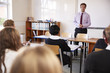 © Monkey Business - Teenage Students Listening To Male Teacher In Classroom