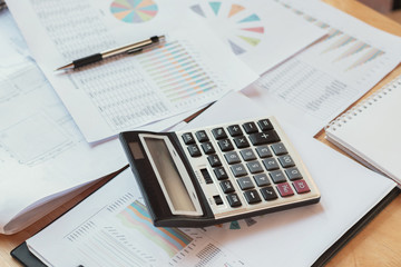 Poster - business financial concept with calculator pen notbook and accounting report on desk