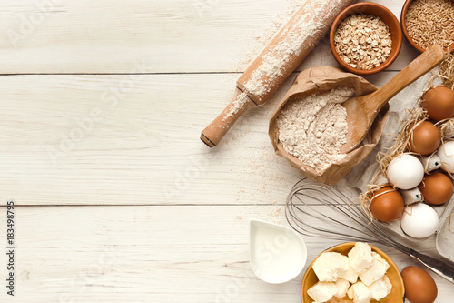 Fotografía Baking background with eggs and flour on white rustic wood
