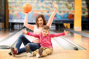 Wall Mural - Family having fun in bowling club