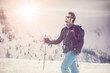skier man detail with sunglasses. exploring snowy land walking and skiing with alpine ski. Europe Alps. Winter sunny day, snow, wide shot, warm sun flare.travelling