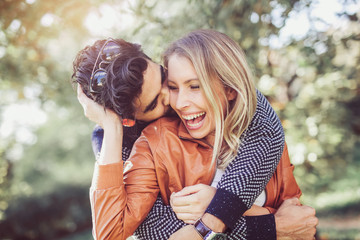 Happy couple in love having fun outdoors and smiling.