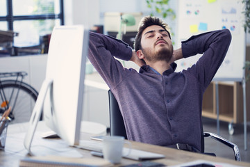 Relaxed businessman working  on computer