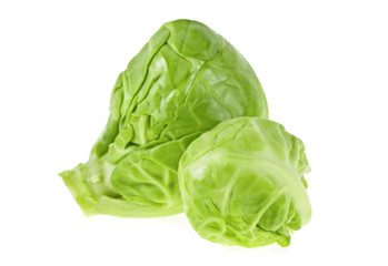 Two fresh green brussel sprouts on a white background