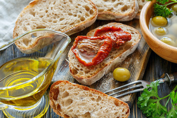 Wall Mural - Fresh ciabatta, olives, oil and sun-dried tomatoes.