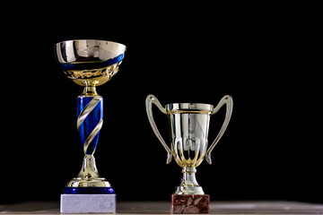 prize, a cup standing on the table. Cup award on a black background.