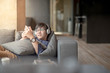 © zephyr_p - Young Asian man using smartphone for listening to music, taking a break and relaxing on sofa in living space, high school or university college student, educational concept