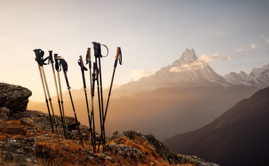 trekking sticks on mountain top background