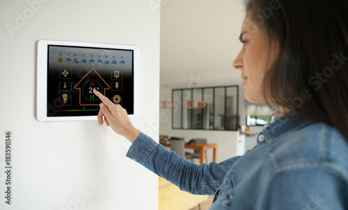 Cuadros en Lienzo Woman using smart wall home control system