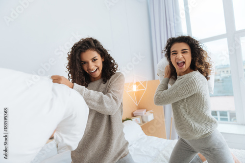 Time For A Pillow Fight Joyful Girls Looking Into The Camera And