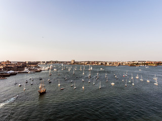 Wall Mural - helicopter flight Aerial view image Boston MA, USA during sunset harbor with boats near waterfront bay