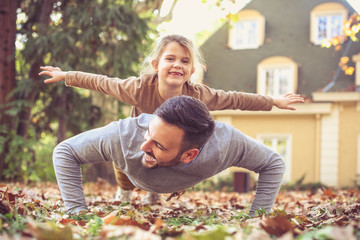 Wall Mural - Daughter flying on Fathers back.