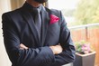 © Wavebreak Media - Man in full suit standing with arms crossed